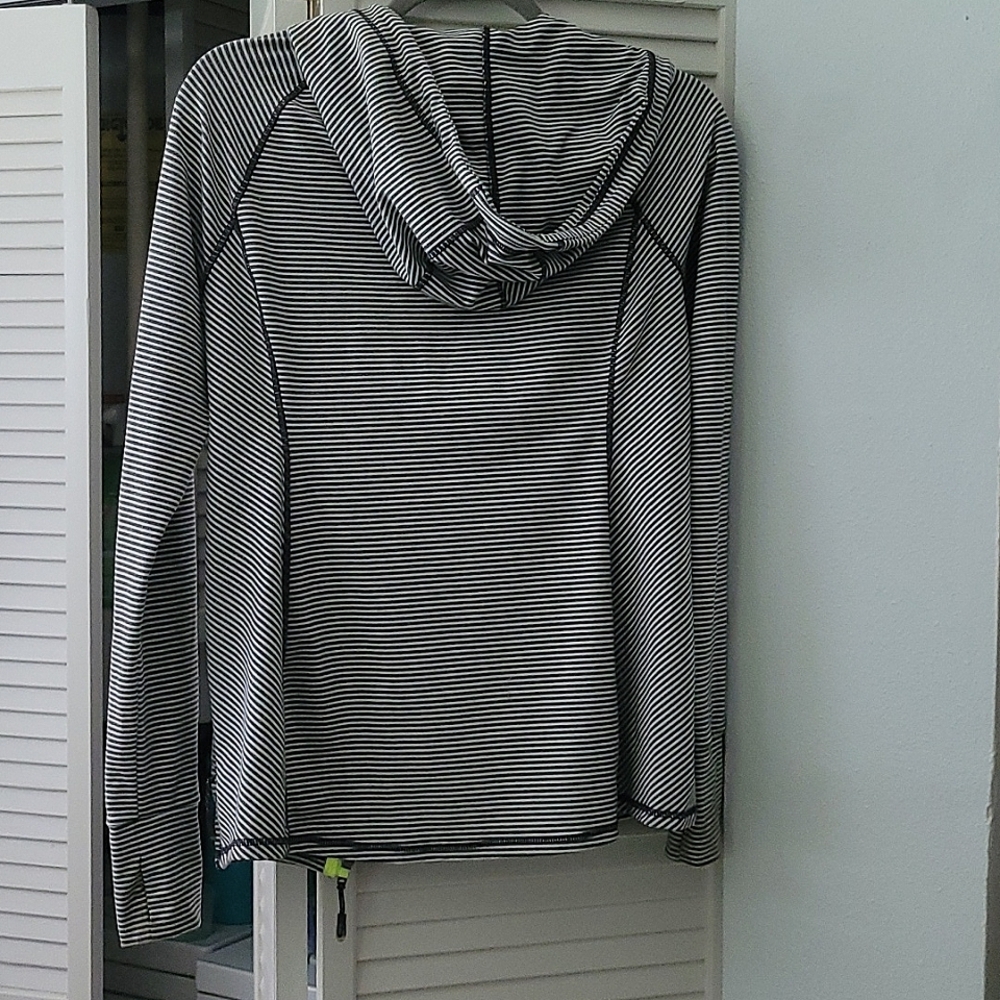 Hooded zippered two pockets sporty sweater with lime green trim.